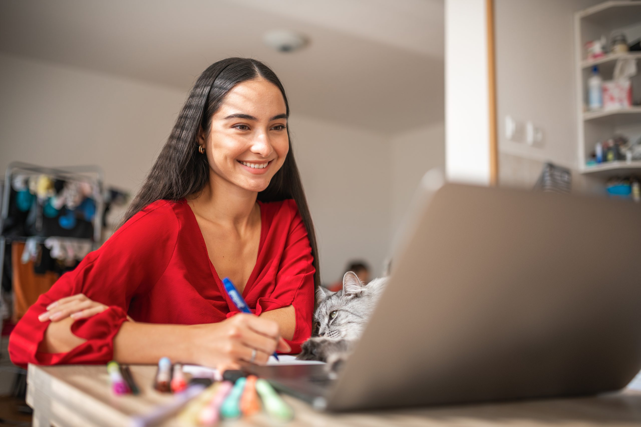 Close Up Of A Young Female Student Taking Notes And Studying Indoors